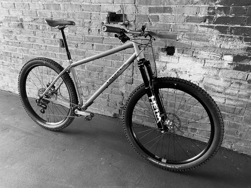 Hardtail mountain bike against a brick wall