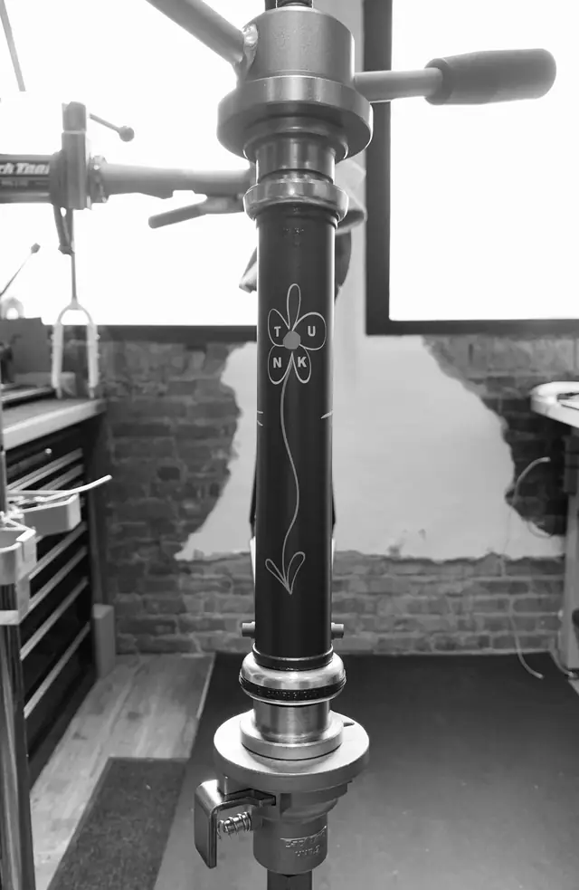 Headset being pressed into an engraved head tube